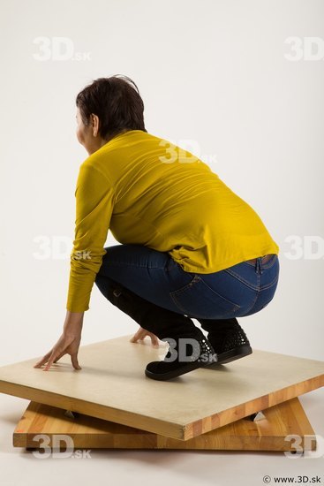 Kneeling reference of yellow sweater blue jeans Gwendolyn