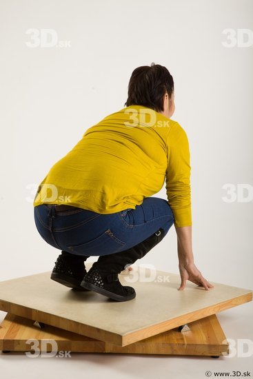 Kneeling reference of yellow sweater blue jeans Gwendolyn