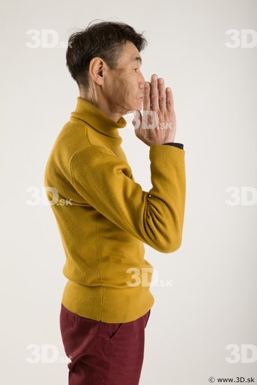 Arm flexing reference of yellow sweater red trousers Sidney