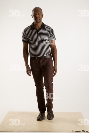 Walking reference of whole body black white striped shirt brown jeans brown shoes Arturo