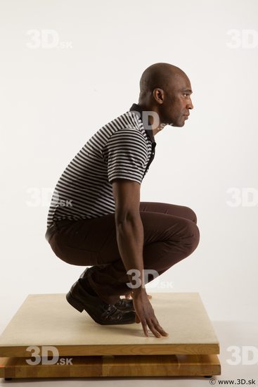 Kneeling reference of whole body black white striped shirt brown jeans brown shoes Arturo