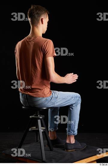 Alessandro Katz  black shoes blue jeans brown t shirt casual dressed sitting whole body  jpg