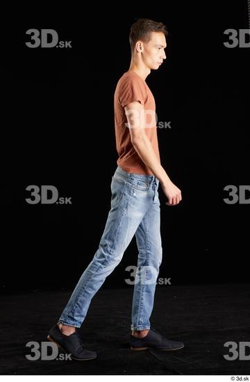 Alessandro Katz  black shoes blue jeans brown t shirt casual dressed side view walking whole body  jpg