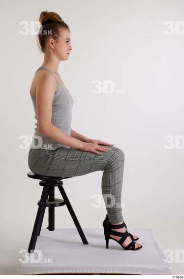 Olivia Sparkle  black high heels sandals casual dressed grey checkered trousers grey tank top sitting whole body  jpg