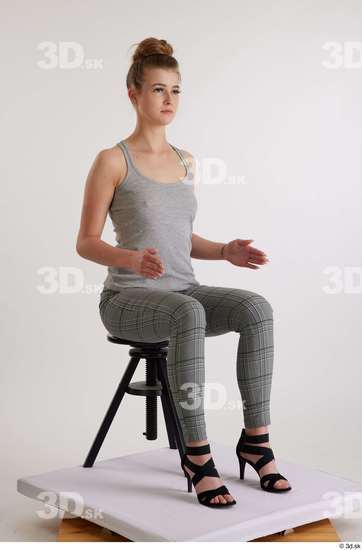 Olivia Sparkle  black high heels sandals casual dressed grey checkered trousers grey tank top sitting whole body  jpg